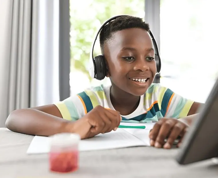 A young learner smiling during an online lesson